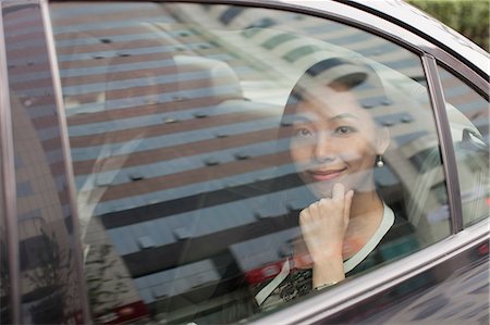 simsearch:6116-07084811,k - Smiling Businesswoman in Car Back Stock Photo - Premium Royalty-Free, Code: 6116-06938890