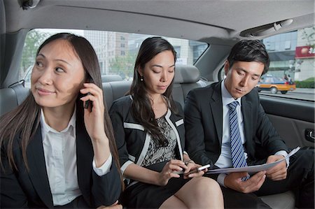 Business People Working in Car Back Stock Photo - Premium Royalty-Free, Code: 6116-06938896