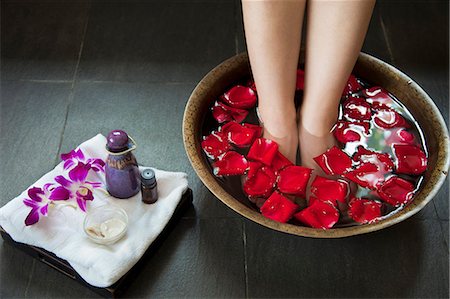 Woman's Feet Soaking in Water with Rose Petals Stock Photo - Premium Royalty-Free, Code: 6116-06938809