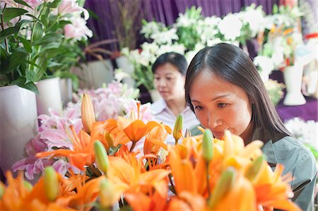 purchase asia - Two Mature women Looking At Flowers In Flower Shop Stock Photo - Premium Royalty-Free, Code: 6116-06938965