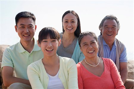 simsearch:6116-07235720,k - Portrait of smiling multigenerational family sitting on the rocks outdoors, China Stock Photo - Premium Royalty-Free, Code: 6116-06939009