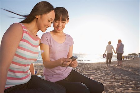 Mother and Daughter looking at camera on the beach Stock Photo - Premium Royalty-Free, Code: 6116-06939023