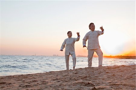 simsearch:693-05552857,k - Two older people practicing Taijiquan on the beach at sunset, China Stock Photo - Premium Royalty-Free, Code: 6116-06939026