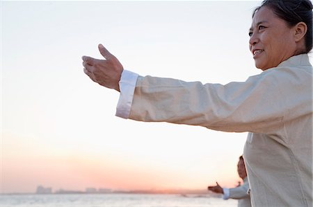 simsearch:693-05552857,k - Two older people practicing Taijiquan on the beach at sunset, China Stock Photo - Premium Royalty-Free, Code: 6116-06939029