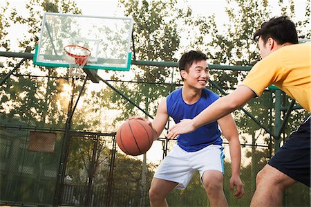 Two street basketball players on the basketball court Stock Photo - Premium Royalty-Free, Code: 6116-06939359