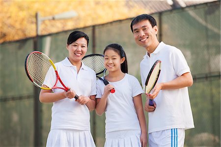 preteen asian girls - Family playing tennis, portrait Stock Photo - Premium Royalty-Free, Code: 6116-06939307