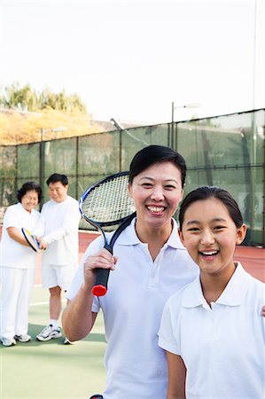simsearch:6116-06939469,k - Young girl playing tennis with her coach Photographie de stock - Premium Libres de Droits, Code: 6116-06939309