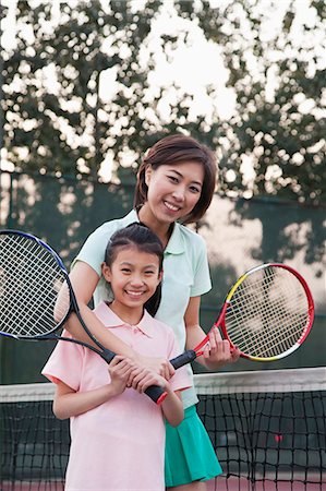 Mother and daughter playing tennis, portrait Stock Photo - Premium Royalty-Free, Code: 6116-06939325