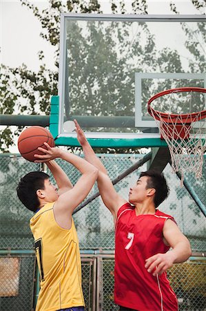 pitcher (sports) - Two people playing basket ball Stock Photo - Premium Royalty-Free, Code: 6116-06939338