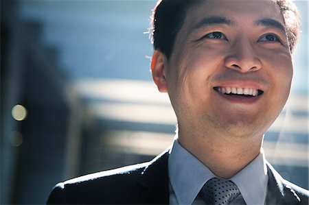 Portrait of smiling businessman in a parking garage Stock Photo - Premium Royalty-Free, Code: 6116-06939403