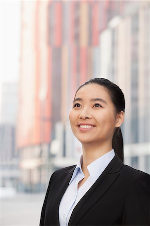 simsearch:6116-07084811,k - Portrait of smiling young businesswoman, looking up Stock Photo - Premium Royalty-Free, Code: 6116-07084502