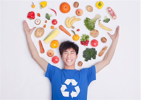 environmentalist - Young man with fresh fruit and vegetables, studio shot Stock Photo - Premium Royalty-Free, Code: 6116-07084660