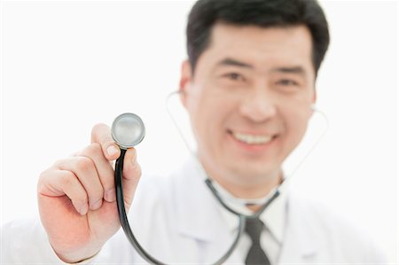 simsearch:694-03331631,k - Doctor Holding Stethoscope, Close-up on Stethoscope Stock Photo - Premium Royalty-Free, Code: 6116-07084877