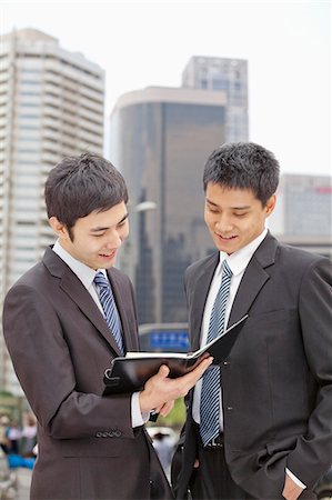 simsearch:6116-07084811,k - Two Businessmen Looking at Note Pad Stock Photo - Premium Royalty-Free, Code: 6116-07084804