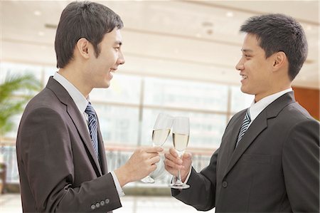simsearch:6116-07084811,k - Two Businessmen Toasting Champagne Flutes Stock Photo - Premium Royalty-Free, Code: 6116-07084805