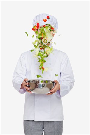 Chef tossing a salad, studio shot Foto de stock - Sin royalties Premium, Código: 6116-07084907