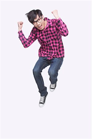 Young Man Jumping Foto de stock - Sin royalties Premium, Código: 6116-07085045