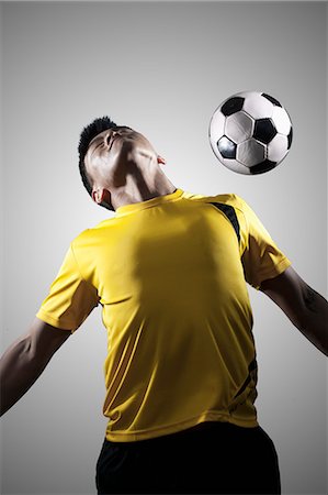Soccer Player Chest Bumping a Ball Foto de stock - Sin royalties Premium, Código: 6116-07085149