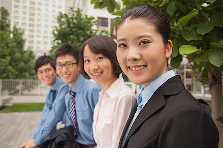 simsearch:6116-07084811,k - Young business people smiling and looking at the camera, portrait Stock Photo - Premium Royalty-Free, Code: 6116-07085571