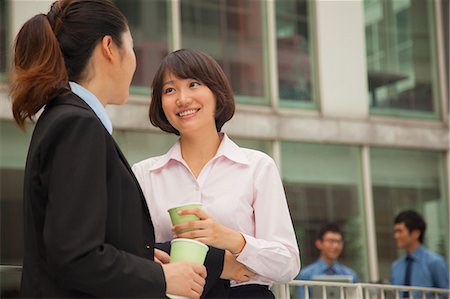simsearch:6116-07084811,k - Businesswomen talking and drinking coffee outdoors Stock Photo - Premium Royalty-Free, Code: 6116-07085578