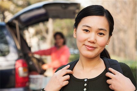 portrait ethnic asia - Portrait of girl in front of car on college campus Stock Photo - Premium Royalty-Free, Code: 6116-07086145