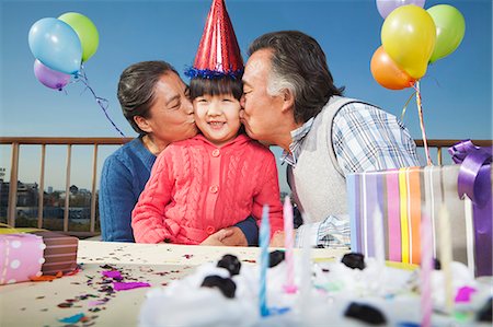Grandparents celebrating birthday of granddaughter Stock Photo - Premium Royalty-Free, Code: 6116-07086103