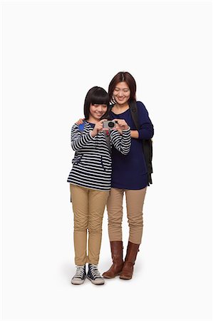 Mother and daughter trying digital camera Stock Photo - Premium Royalty-Free, Code: 6116-07086255