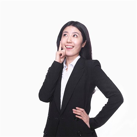 Businesswoman with hand on chin thinking Stock Photo - Premium Royalty-Free, Code: 6116-07086340