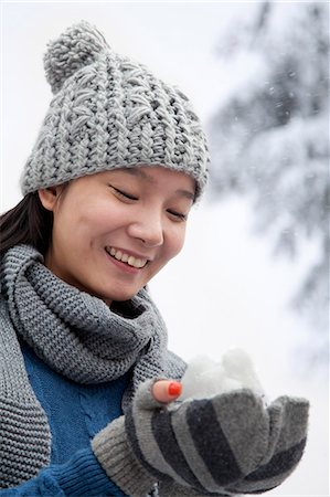 people playing in the snow - Young Woman with Snowball Stock Photo - Premium Royalty-Free, Code: 6116-07086421