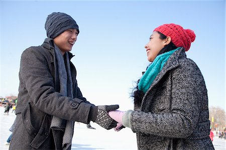 Young couple holding hands at ice rink Stock Photo - Premium Royalty-Free, Code: 6116-07086564