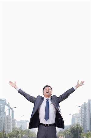 simsearch:632-03403433,k - Young Businessman with Arms Raised Stock Photo - Premium Royalty-Free, Code: 6116-07235380