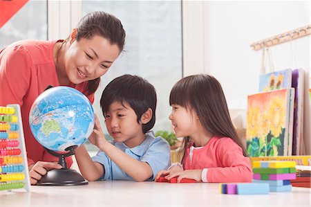 Students And Teacher Looking at Globe Stock Photo - Premium Royalty-Free, Code: 6116-07235586