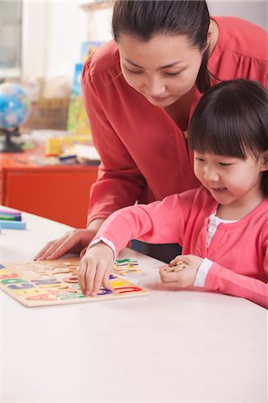 simsearch:6116-06939469,k - Teaching Helping Young Girl with Cut-Out Alphabet Letters Photographie de stock - Premium Libres de Droits, Code: 6116-07235590