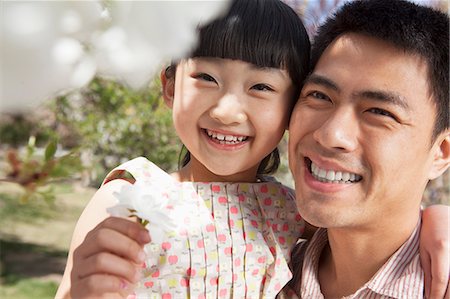 simsearch:6116-07236315,k - Smiling father and daughter enjoying the cherry blossoms on the tree in the park in springtime Foto de stock - Sin royalties Premium, Código: 6116-07235871