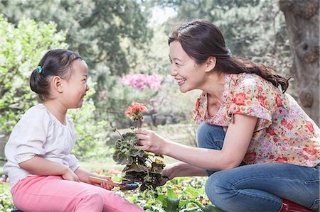 flower for mom asian - Mother and daughter planting flowers. Stock Photo - Premium Royalty-Free, Code: 6116-07235920