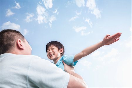 Father lifting son. Stock Photo - Premium Royalty-Free, Code: 6116-07235929