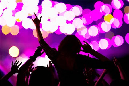 silhouette people performing - Audience watching a rock show, rear view, stage lights Stock Photo - Premium Royalty-Free, Code: 6116-07236046