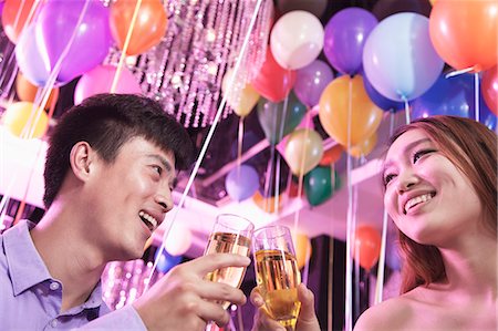 simsearch:6116-07236256,k - Two friends celebrating, toasting with champagne, nightclub in Beijing, balloons in the background Stock Photo - Premium Royalty-Free, Code: 6116-07236067