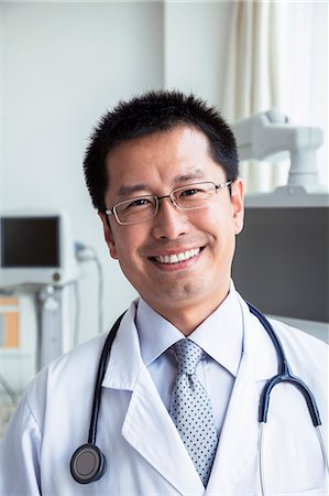 professional occupation - Portrait of smiling doctor with a stethoscope looking at camera Stock Photo - Premium Royalty-Free, Code: 6116-07236101