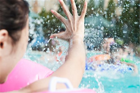 pictures girl swimming to colour - Young smiling family splashing and playing in the pool Stock Photo - Premium Royalty-Free, Code: 6116-07236389