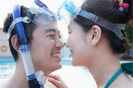 simsearch:6116-07236315,k - Smiling couple face to face in snorkeling gear in the pool Foto de stock - Sin royalties Premium, Código: 6116-07236422