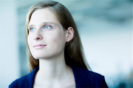 Portrait of young businesswoman looking away in contemplation Stock Photo - Premium Royalty-Free, Code: 6116-07236561