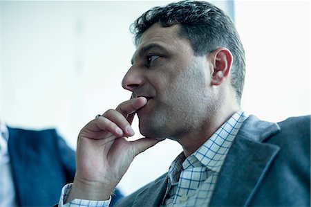 pensativo - Businessman listening in a business meeting Foto de stock - Sin royalties Premium, Código: 6116-07236584