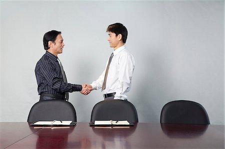 simsearch:655-03458001,k - Two Businessmen Shaking Hands Stock Photo - Premium Royalty-Free, Code: 6116-08311873