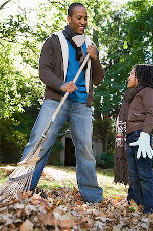 raking leaves autumn - Father and daughter raking leaves Stock Photo - Premium Royalty-Free, Code: 6116-08945520