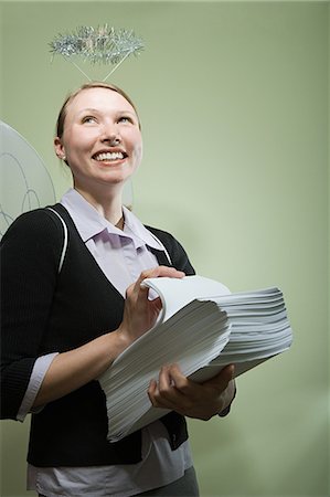 simsearch:693-06435933,k - Office angel holding paperwork Stock Photo - Premium Royalty-Free, Code: 6116-08945644