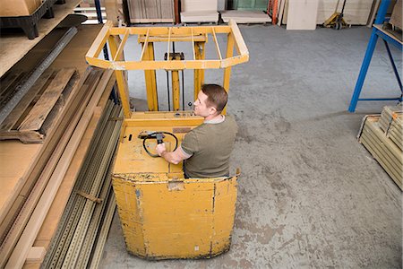 small business, inventory - Man in forklift truck Stock Photo - Premium Royalty-Free, Code: 6116-08915246