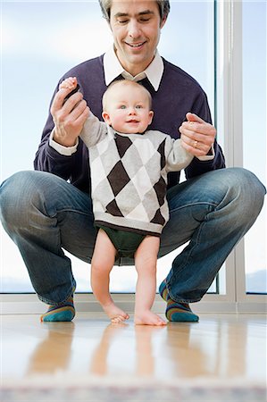 simsearch:859-06808650,k - father helping his son walk Stock Photo - Premium Royalty-Free, Code: 6116-08915277