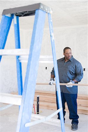 simsearch:700-00404021,k - A builder holding a plank of wood Stock Photo - Premium Royalty-Free, Code: 6116-08915397