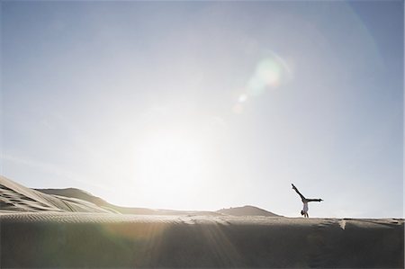 dried human bodies - Woman doing handstand in desert Stock Photo - Premium Royalty-Free, Code: 6116-08915498